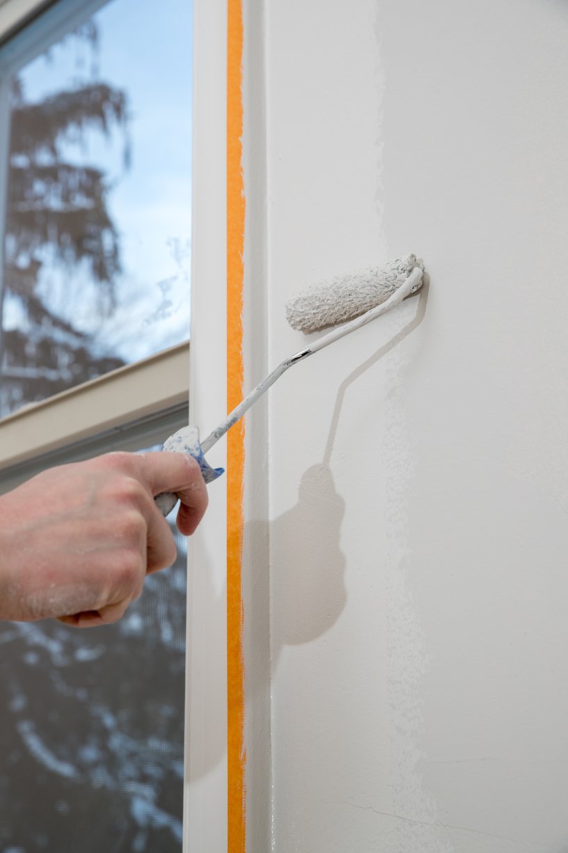 painting apartment renovating with white color paint roller room